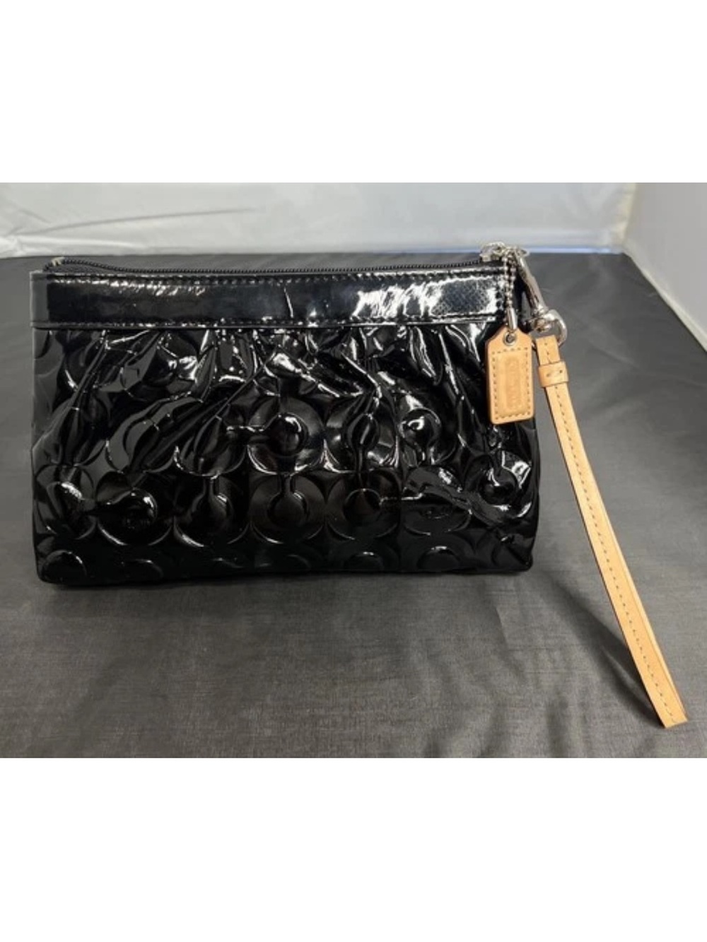 Coach embossed black patent leather op art wristlet